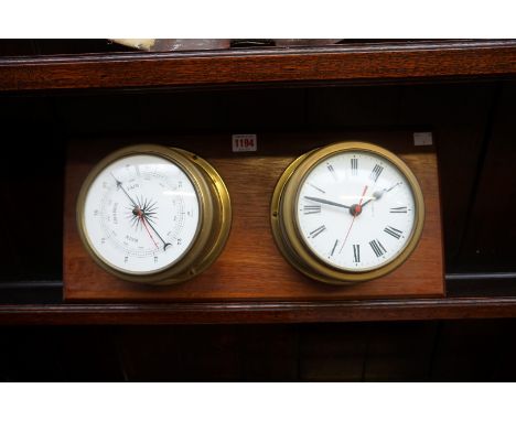 A brass clock and barometer set, on mahogany plaque, 49.5 x 22cm. 