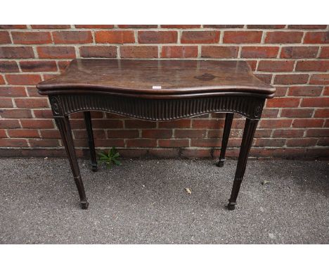 A George III carved mahogany serpentine fronted card table,&nbsp;with fluted frieze and legs, with double gateleg action, 96.