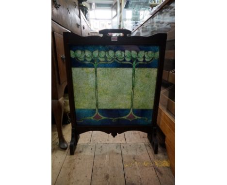 An Art Nouveau oak framed firescreen, with gilt metal wire and beadwork panel, 54.5cm wide. 