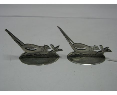 A Pair of Hallmarked Silver Menu Holders, SD Ltd, London 1913, each as a pheasant, on shaped oval base. (2)