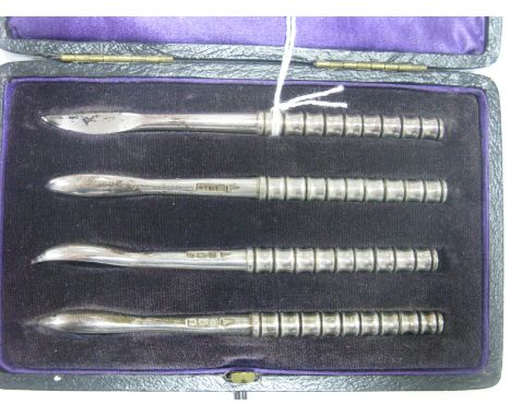 A Set of Four Hallmarked Silver Picks/Stoners, each with textured handle, in original fitted case.