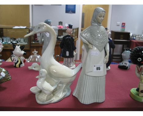 A Miquel Requena Pottery Figure, of a lady sporting head scarf, 31.5cm high and geese group. (2)