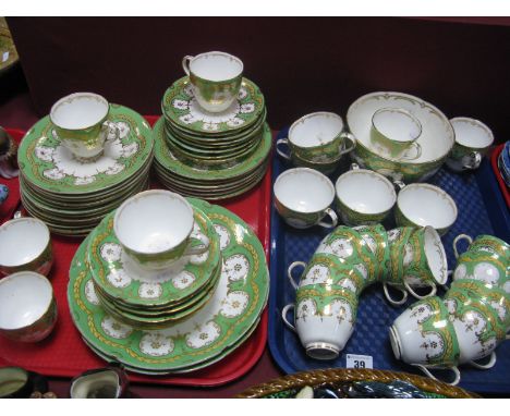 A XIX Century Tea Service, with a green ground, gilt highlights (kite mark on the base of teacups and saucers), (over sixty p