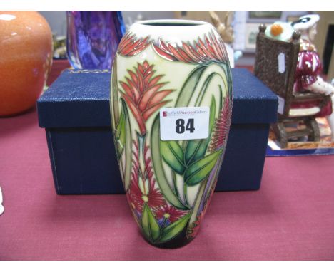 A Modern Moorcroft Pottery Vase, of extended ovoid form, painted with exotic plants and foliage against a shaded dark green i