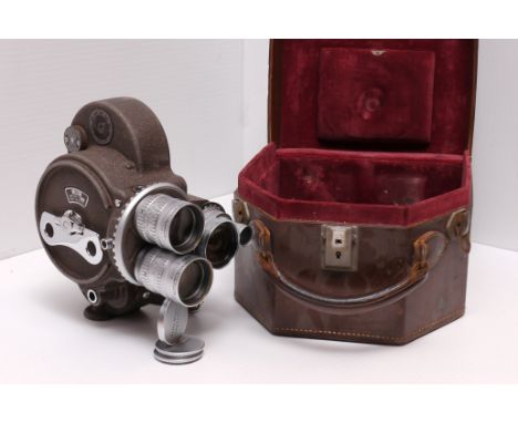 A Bell & Howell Filmo 70 Cine Camera, with Angenieux f/2.5 3", f/0.95 1" and f/1.8 10mm lenses, in maker's case