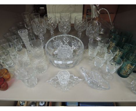 A shelf of glassware including wine glasses, bowl, whiskey tumblers etc