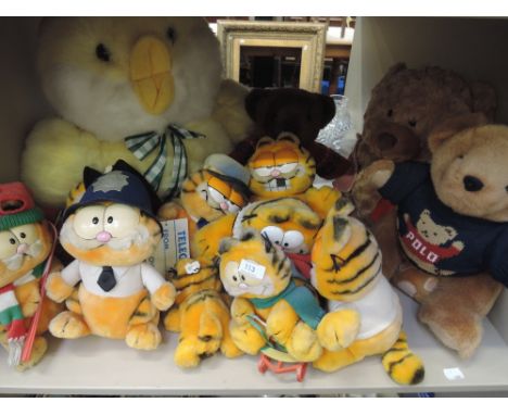 A shelf of stuffed toys including Garfield