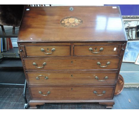 A 19th Century mahogany bureau having foliate inlay decoration on bracket feet