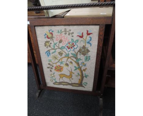 A traditional oak and tapestry fire screen