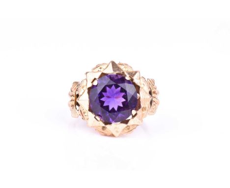 An 18ct yellow gold and amethyst dress ring, circa 1950s, set with a mixed round-cut amethyst, meausring approximately 6 mm d