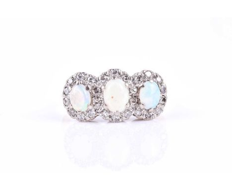 An 18ct yellow gold, diamond, and opal ring, set with three oval cabochon opals within a border of round single-cut diamonds,