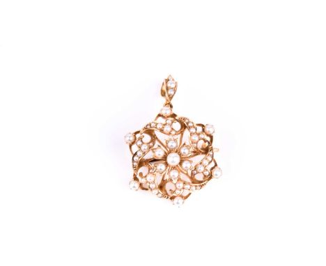 A 15ct yellow gold and seed pearl pendant / brooch, of circular design, centred with a floral cluster within a waved mount of