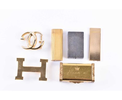 A Cartier lighter, gilt metal, of ribbed design, together with a white metal Dupont lighter, a ladies brass compact engraved 