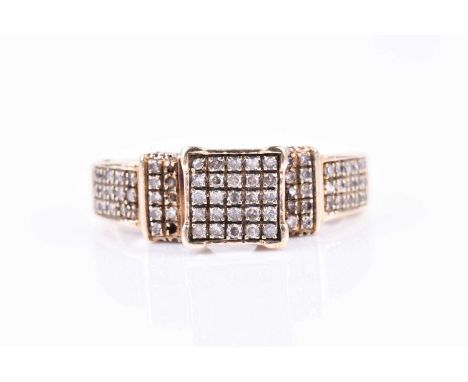 A yellow metal and diamond ring, pave-set with small round brilliant-cut diamonds in a squared mount, with squared details to