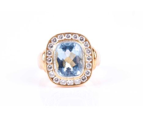 An impressive diamond and aquamarine cocktail ring, centred with a mixed rectangular cushion-cut aquamarine, within a channel