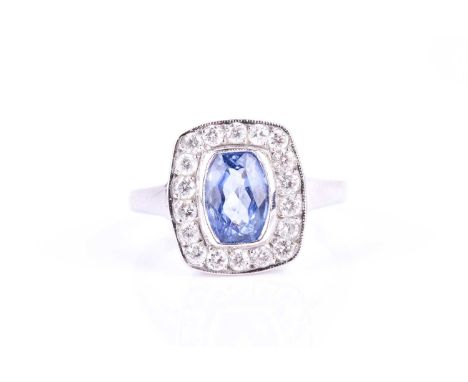 An 18ct white gold, diamond, and sapphire ring, set with a mixed rectangular cushion-cut blue sapphire of approximately 1.50 