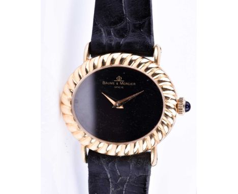 A Baume and Mercier ladies wristwatch, the oval black dial with yellow metal ribbed bezel, numberless dial, numbered 708438 3