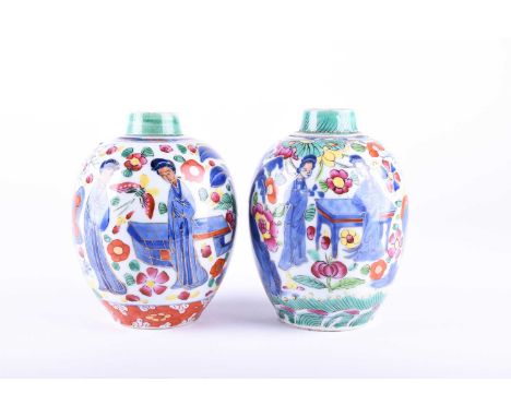 A near pair of Kangxi period porcelain caddies, early 18th century, European decorated, the underglaze blue decoration of fem