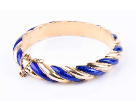 A yellow gold and cobalt blue enamel bangle, of twisted design, unmarked (tests as 18ct gold), internal diameter 5.6 cm, 45 g
