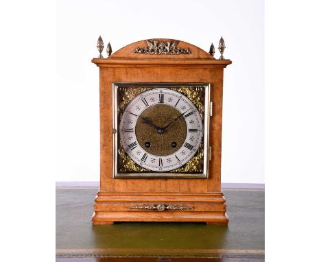 A late 19th century walnut cased bracket clock by Lenzkirch, with dome top cornered by four brass pineapple finials, the eigh