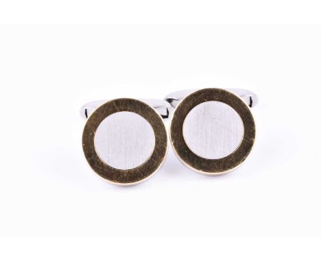 Chopard. A pair of stainless steel and gold cufflinks, of circular form, with gilt borders to a central steel circle, maked C
