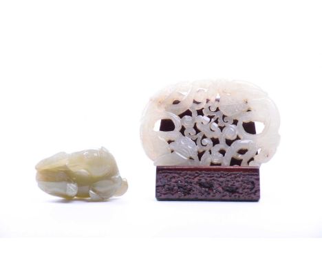 A Chinese Jade carving, late Qing, carved as two opposing chilong amongst rui shape fronds, on wood stand, 7cm, together with