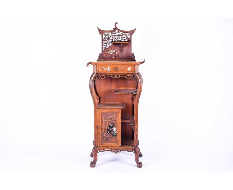 A late 19th century Aesthetic Movement Japonesque carved walnut side cabinet, the top with pierced panel and small shelf with