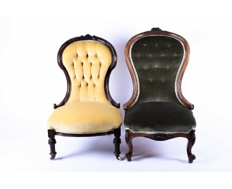 Two Victorian button-back easy chairs, with carved show wood frames, one rosewood, the other mahogany. (2)