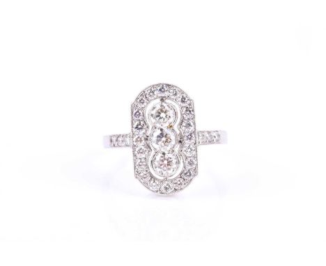 A platinum and diamond ring, the lozenge-shaped mount centred with a row of three round brilliant-cut diamonds within a borde