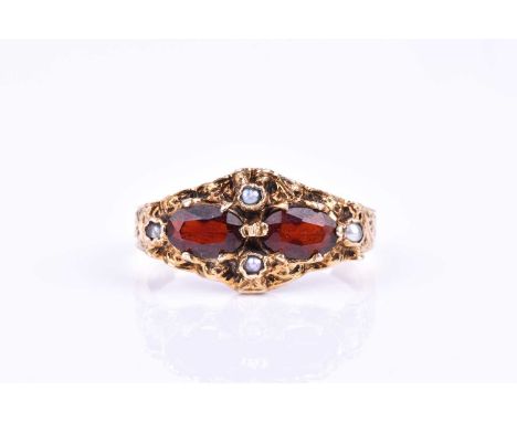 A 9ct yellow gold, garnet, and pearl ring, set with two mixed oval-cut garnets and four pearls, the mount and shank with orna
