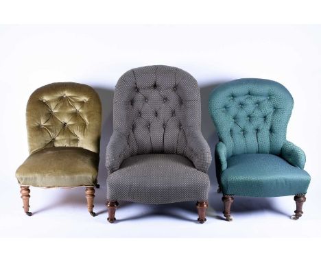 Three button-back easy chairs, all with turned legs and upholstered in differing fabrics.