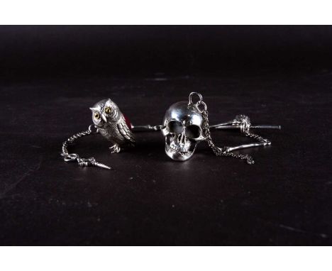 A novelty Sterling silver chatelaine, modelled as a human skull, the chain with formed as other body parts and bones, 31 cm l