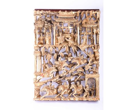 A Chinese Chaozhou style carved and gilded wood panel, 20th century, carved with a dignitary and court officials overseeing w