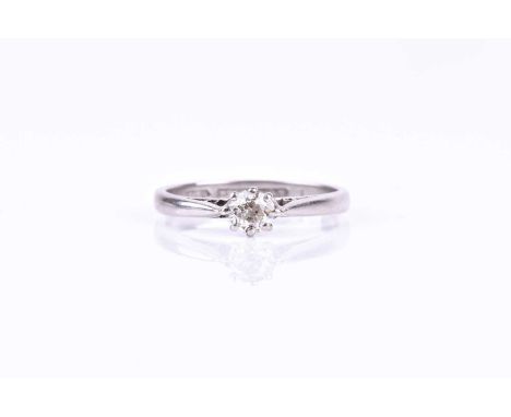 A platinum and solitaire diamond engagement ring, set with a round brilliant-cut diamond of approximately 0.25 carats, size K