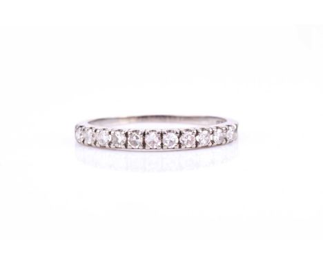 An 18ct white gold and diamond half eternity ring, set with eleven eight-cut diamonds, each approximately 0.02 carats, size N