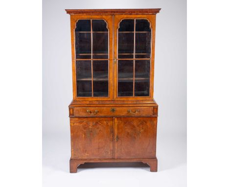 An 18th century walnut and oyster wood secretaire bookcase, the top with a pair of astragal glazed doors enclosing adjustable