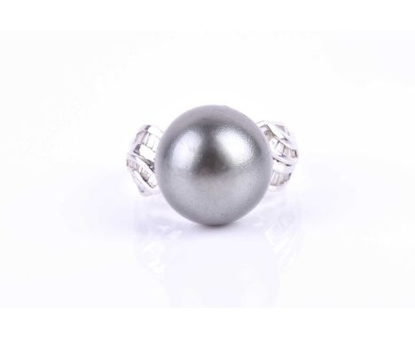 An 18ct white gold, diamond, and dark grey Tahitian pearl ring, the pearl approximately 14 mm diameter, the shoulders channel