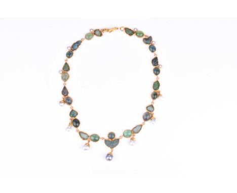 An unusual yellow gold, green tourmaline, and pearl necklacecomprised of alternating carved leaf-design tourmalines and caboc