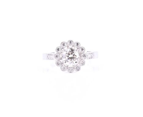 An 18ct white gold and diamond halo cluster ring, centred with a round brilliant-cut diamond of approximately 0.78 carats, su