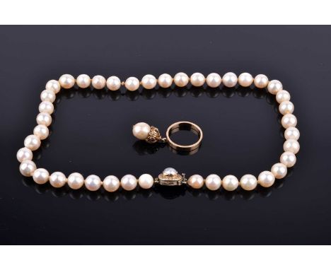 A pearl necklace, formed of creamy white cultured pearls, 38 cm long, fastened with a yellow metal and pearl clasp inset with