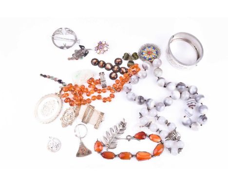 A group of jewellery items including a white metal bangle with engraved detail, together with a white metal and red agate bra