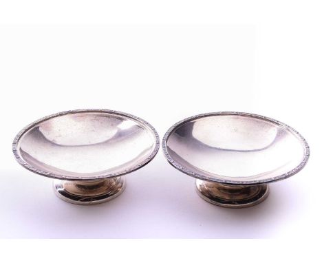 A pair of silver pedestal dishes, James Edward Barry, Sheffield 1942, the circular dishes with a beaded and scrolling foliate
