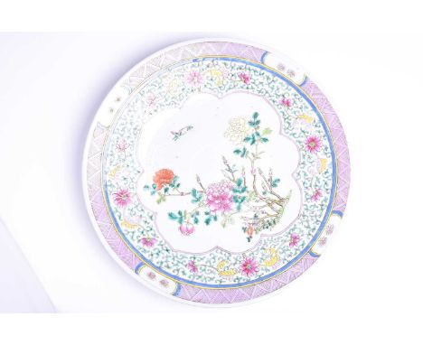 A Chinese Famille rose dished charger, late 19th/early 20th century, painted with blossoming peony and insects, withing a lot