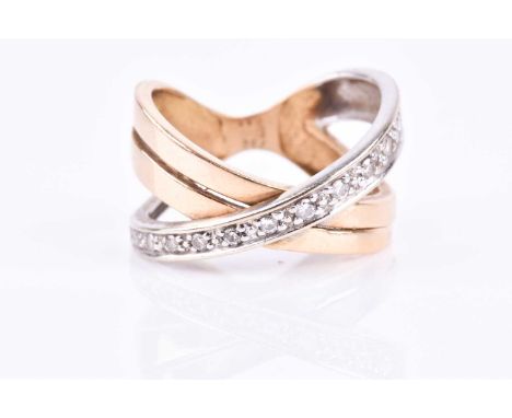 A yellow metal crossover ring, set with a band of small round-cut diamond accents in white metal mounting, the other half of 
