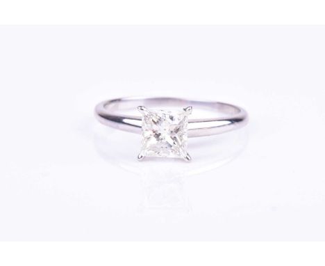 A princess-cut single stone diamond ringthe diamond approximately I/J colour, I1-2 clarity, four claw set in white metal moun