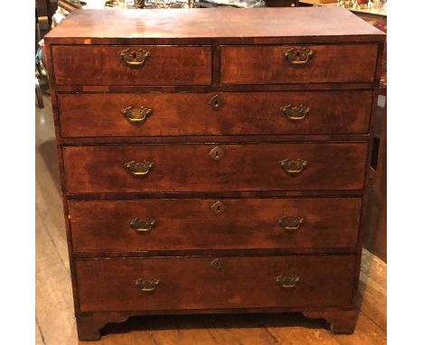 A George III oak and mahogany crossbanded chest of drawers, circa 1800, caddy top above two short and four long gradual drawe