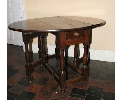 A late 17th century style oak gate leg table with fitted draw, turned legs joined by plain stretchers 66.5cm H x 90cm W x 109