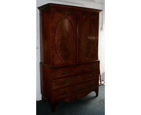 A 19th century crossbanded mahogany linen press, moulded cornice, above two cupboard doors enclosing two shelves, above three