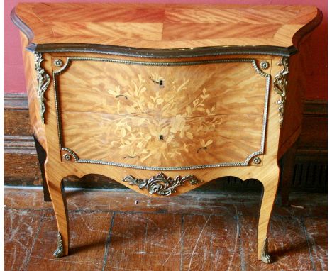 A Louis XV style commode, mid 20th century, serpentine inlaid and crossbanded top with stepped moulding, metal mounts through
