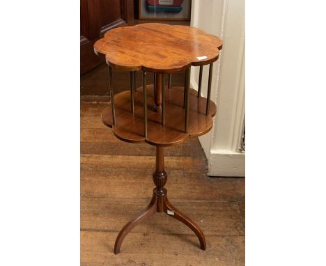 A late Victorian mahogany and satinwood strung swivel bookcase, circa 1890, aesthetic movement floral carved shaped top and b